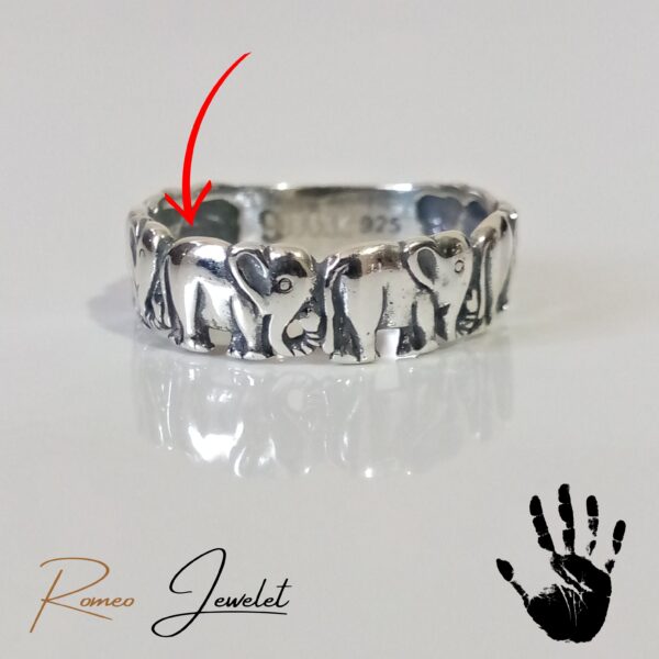 Elegante anillo con seis elefantes esculpidos en plata pura, una joya distintiva.